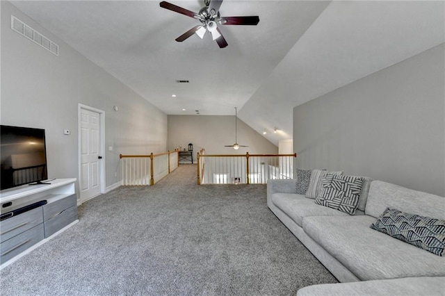 living room with carpet flooring, vaulted ceiling, a ceiling fan, and visible vents