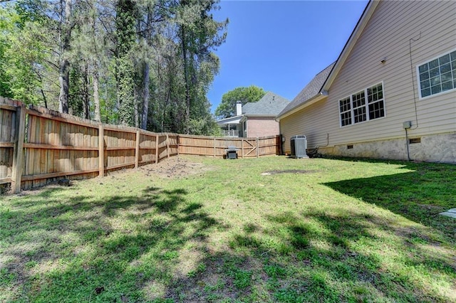 view of yard featuring central AC and a fenced backyard