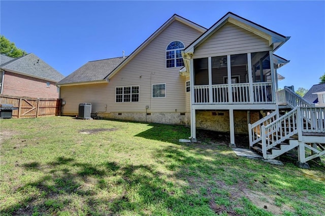 rear view of property featuring a sunroom, a yard, crawl space, cooling unit, and stairs
