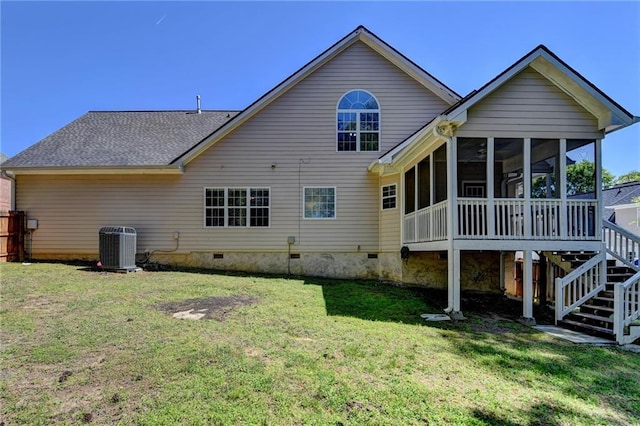 rear view of property with central air condition unit, stairway, crawl space, a yard, and a sunroom