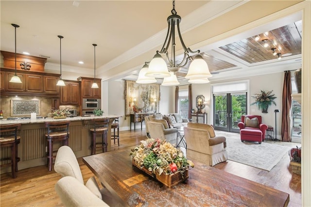 dining space with light wood-type flooring, ornamental molding, and recessed lighting