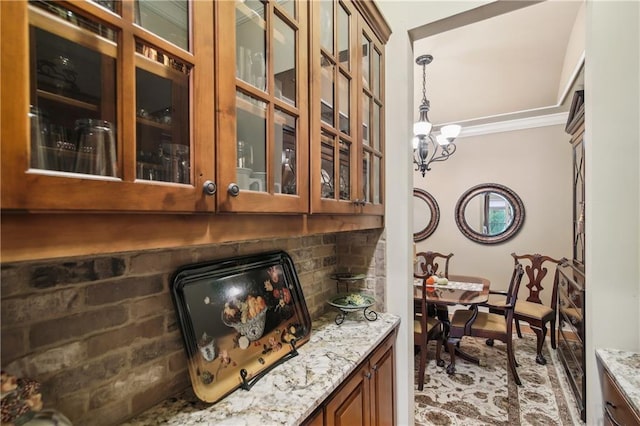 interior space with a notable chandelier, pendant lighting, and ornamental molding