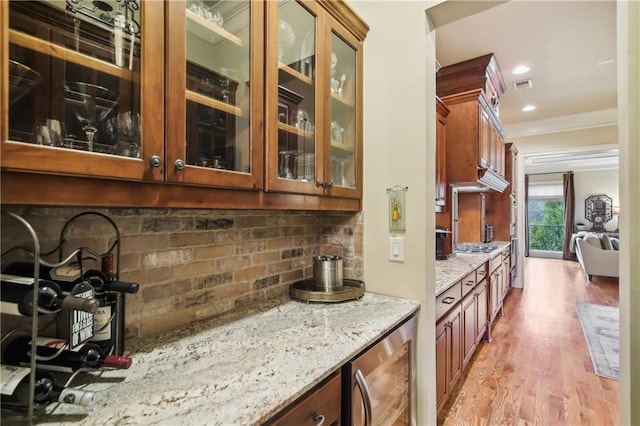 bar with light wood-type flooring, ornamental molding, visible vents, wine cooler, and decorative backsplash
