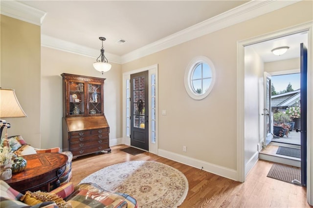 foyer featuring visible vents, wood finished floors, and a healthy amount of sunlight