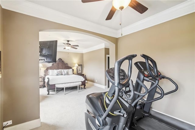 bedroom with arched walkways, a ceiling fan, ornamental molding, carpet floors, and baseboards