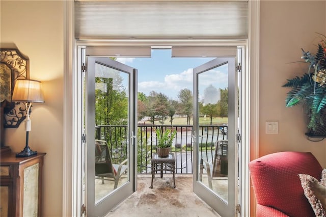 doorway to outside with unfinished concrete flooring
