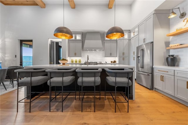 146 Overlook Way, Blue Ridge, GA 30513 - kitchen with wall chimney exhaust hood, high quality fridge, a high ceiling, beamed ceiling, and decorative backsplash