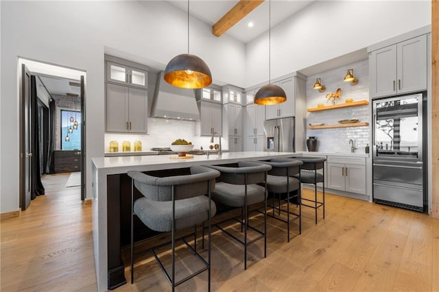 146 Overlook Way, Blue Ridge, GA 30513 - kitchen featuring stainless steel refrigerator with ice dispenser, wall chimney range hood, high end refrigerator, light countertops, and light wood-style floors