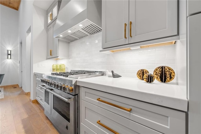 146 Overlook Way, Blue Ridge, GA 30513 - kitchen with wall chimney range hood, double oven range, gray cabinetry, light wood-style flooring, and light countertops