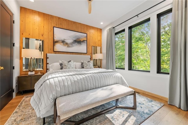 146 Overlook Way, Blue Ridge, GA 30513 - bedroom featuring wooden walls, recessed lighting, baseboards, light wood-style flooring, and an accent wall