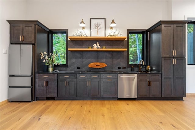 146 Overlook Way, Blue Ridge, GA 30513 - kitchen with appliances with stainless steel finishes, dark countertops, light wood-style flooring, and tasteful backsplash
