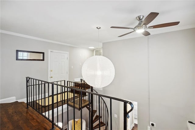 stairway featuring ornamental molding, hardwood / wood-style floors, and ceiling fan