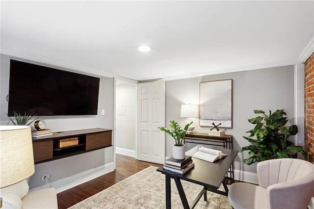 office featuring a brick fireplace, dark hardwood / wood-style floors, brick wall, and crown molding