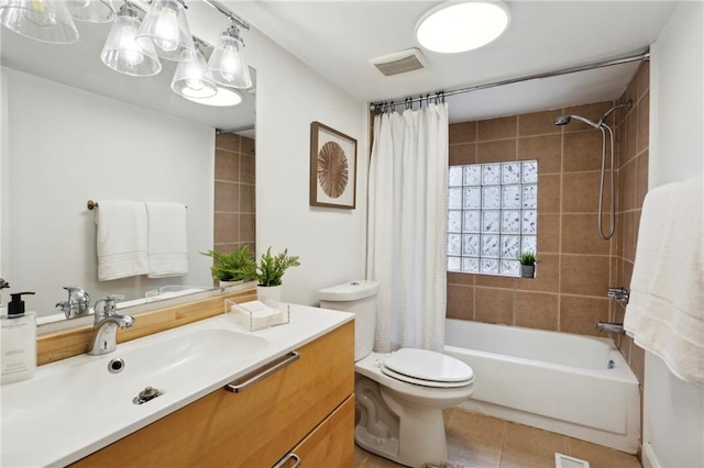 full bathroom featuring shower / bath combination with curtain, vanity, tile patterned flooring, and toilet