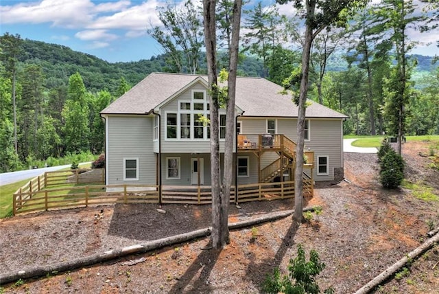 rear view of house featuring a deck with mountain view