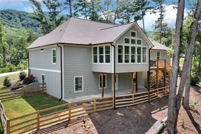 back of property featuring a sunroom and a patio