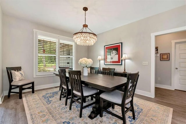 dining area featuring an inviting chandelier and hardwood / wood-style floors