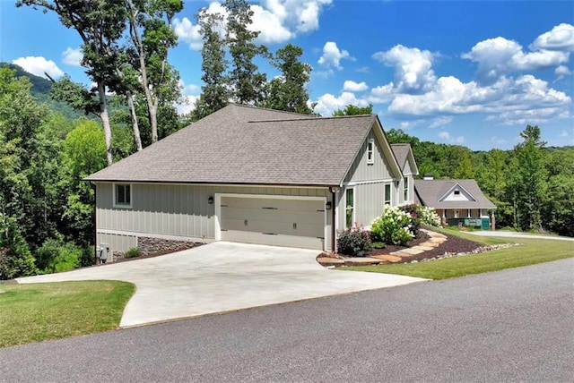 view of front of house with a garage and a front lawn