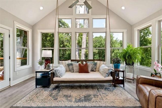 sunroom featuring vaulted ceiling and ceiling fan