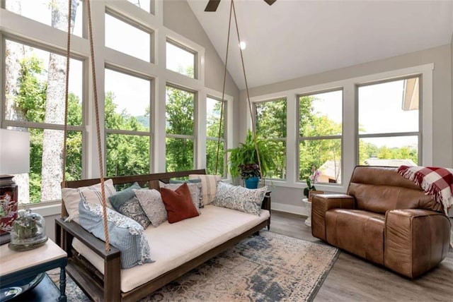 sunroom featuring ceiling fan and lofted ceiling