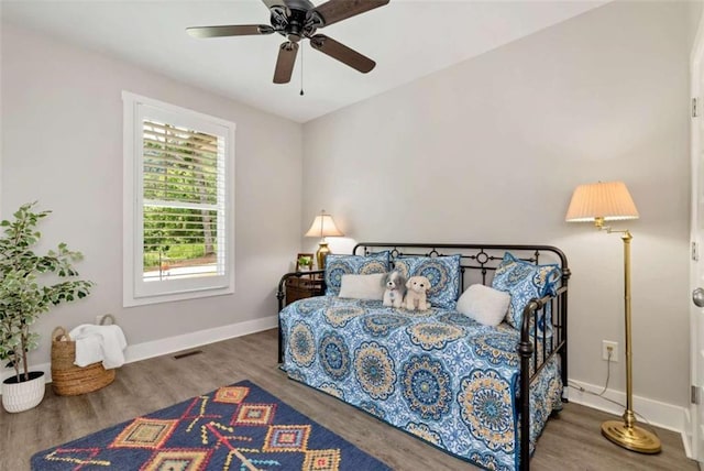 bedroom with dark wood-type flooring and ceiling fan