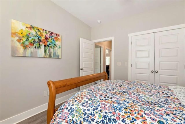 bedroom featuring hardwood / wood-style floors and a closet