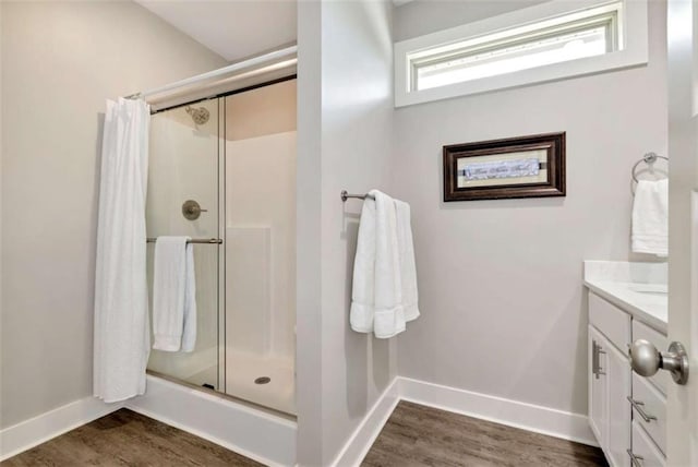 bathroom with a shower with door, vanity, and hardwood / wood-style floors