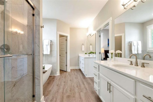 bathroom featuring independent shower and bath, wood-type flooring, tile walls, and vanity