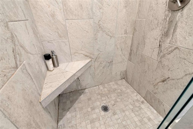 bathroom with a tile shower