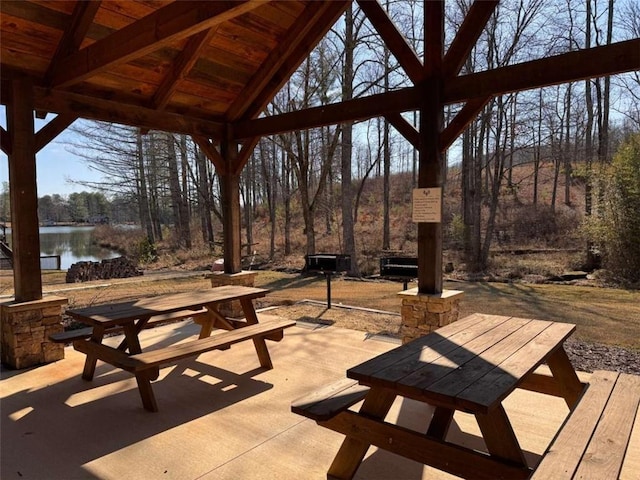 view of patio featuring a gazebo and a water view