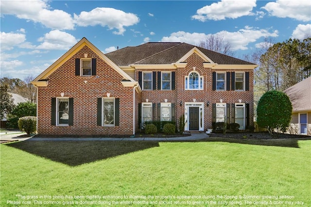 view of front facade with brick siding and a front lawn