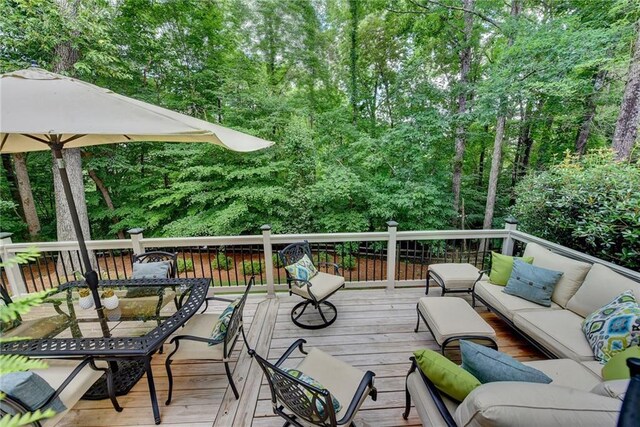 deck featuring an outdoor living space, outdoor dining area, and a pergola