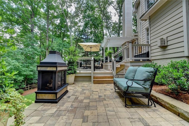 view of patio featuring a wooden deck and a pergola