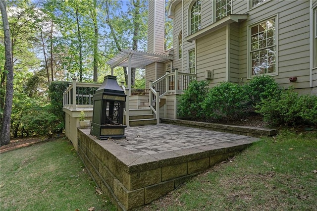 exterior space featuring a lawn, a pergola, and stairs