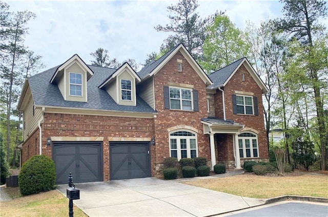 view of front of home with central AC and a garage