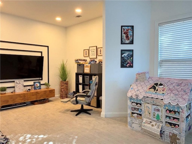 living area featuring light carpet