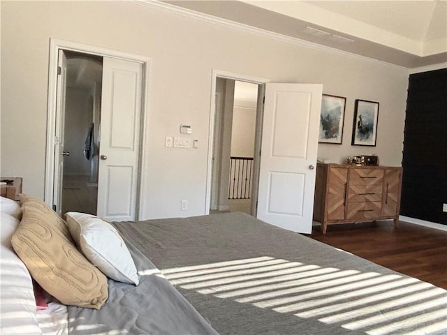 bedroom with crown molding and dark hardwood / wood-style flooring