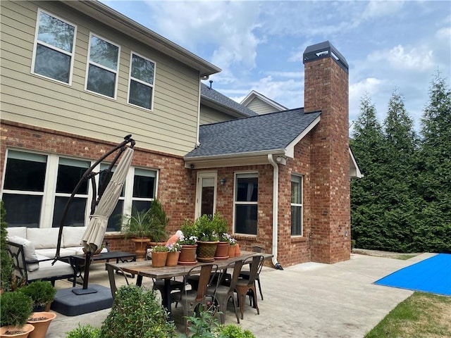 back of house with a patio