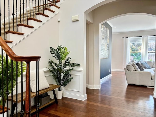 interior space with ornamental molding and dark hardwood / wood-style floors