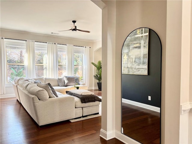 living room with dark wood-type flooring and ceiling fan