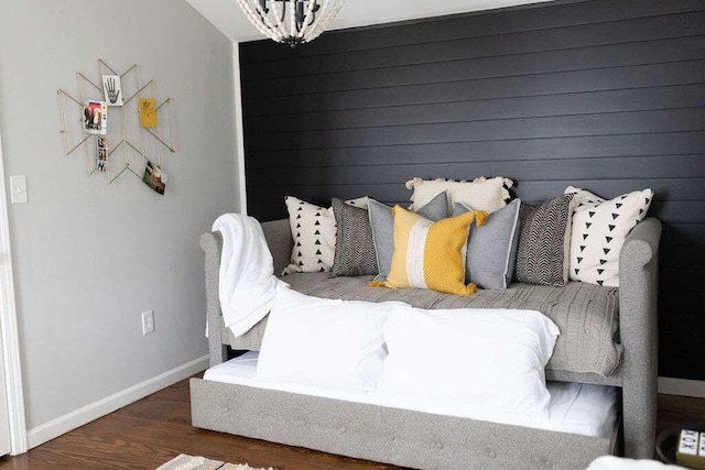 bedroom featuring dark wood-type flooring and a chandelier