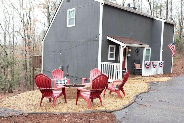 rear view of house with a fire pit