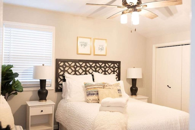 bedroom with multiple windows, ceiling fan, and a closet