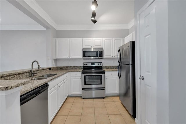 kitchen featuring appliances with stainless steel finishes, light tile patterned floors, sink, white cabinetry, and kitchen peninsula