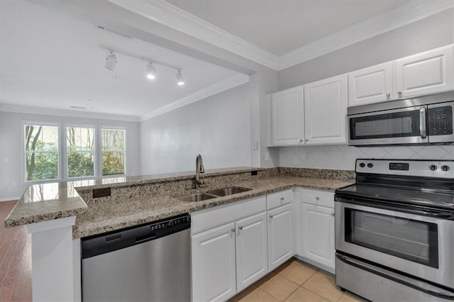 kitchen featuring sink, stainless steel appliances, white cabinetry, and kitchen peninsula