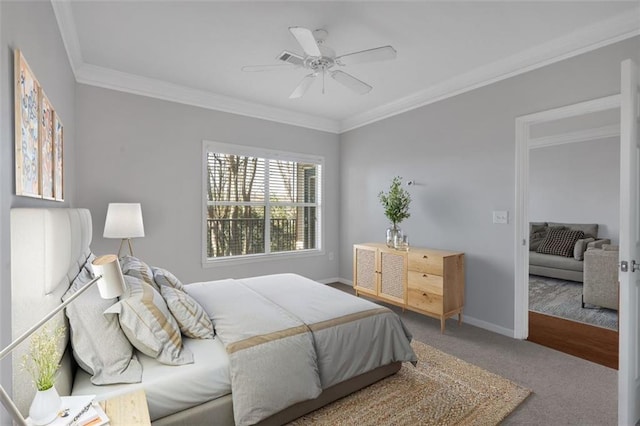 carpeted bedroom with ornamental molding and ceiling fan