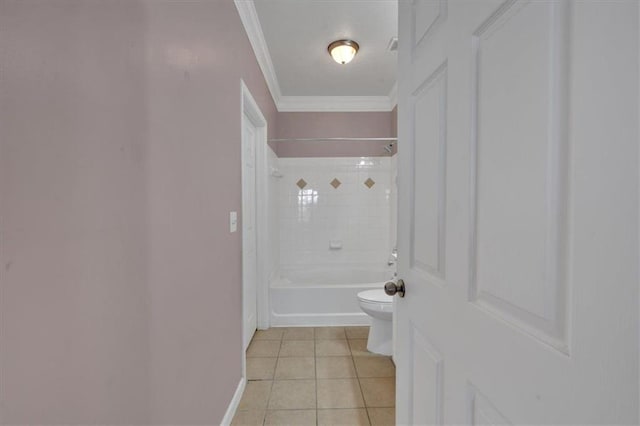 bathroom with tile patterned floors, ornamental molding, tiled shower / bath, and toilet