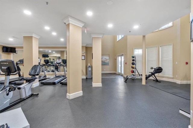 gym featuring crown molding and decorative columns