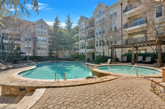 view of pool featuring a pergola and a community hot tub