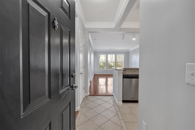 entryway with ornamental molding and light tile patterned flooring